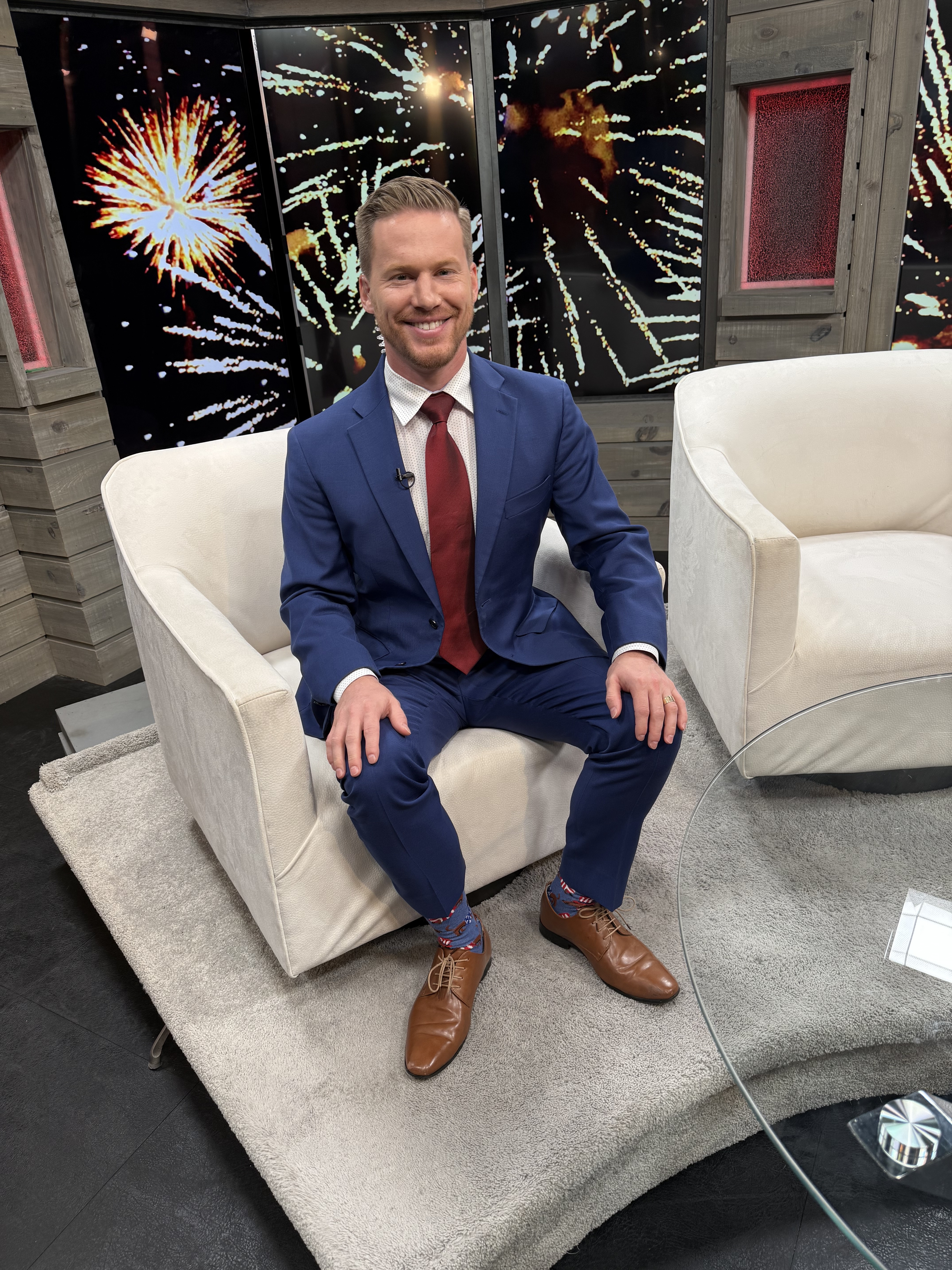 Matt Bennett seated in a television studio